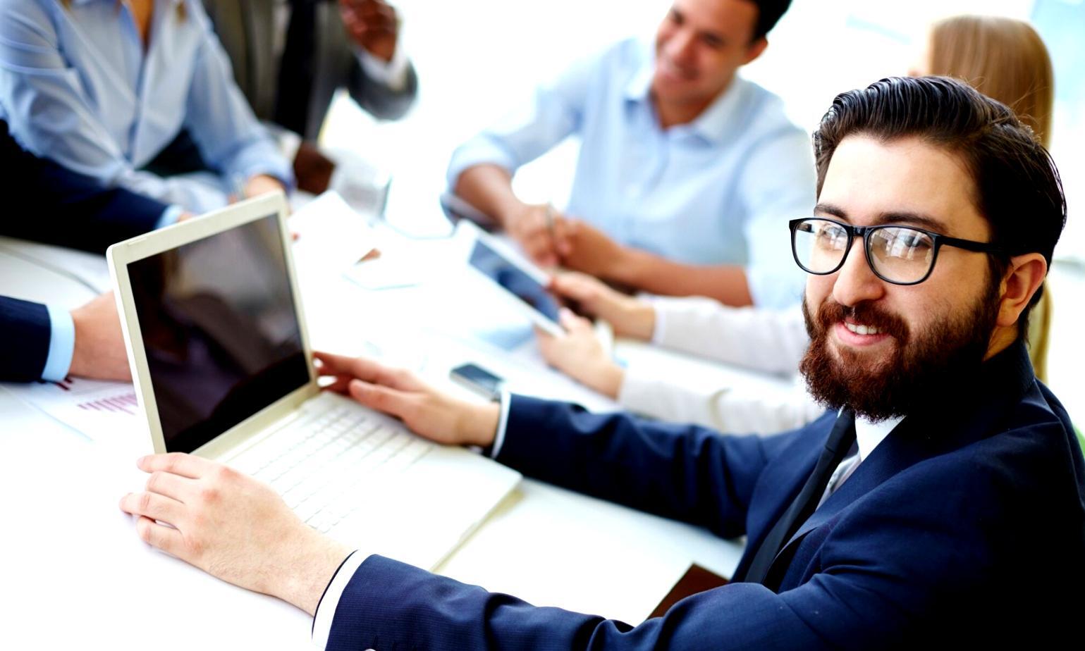 Organized financial planning session with documents, charts and digital tools spread across a professional workspace